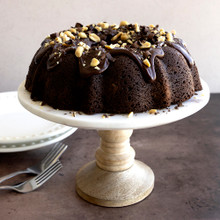 Nordic Ware 12-cup formed bundt pan with chocolate bundt cake, chocolate frosting, nuts and chocolate shavings