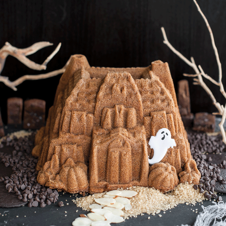 Animated GIF of chocolate bundt cake from Nordic Ware Haunted Manor pan with candy ghosts appearing and disappearing