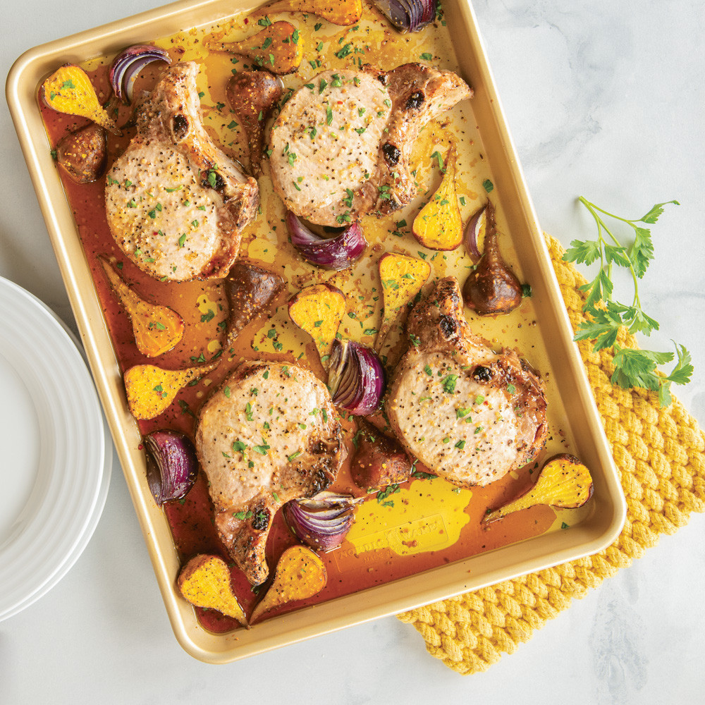 Nordic Ware aluminum half sheet pan with baked pork chops, golden nonstick surface