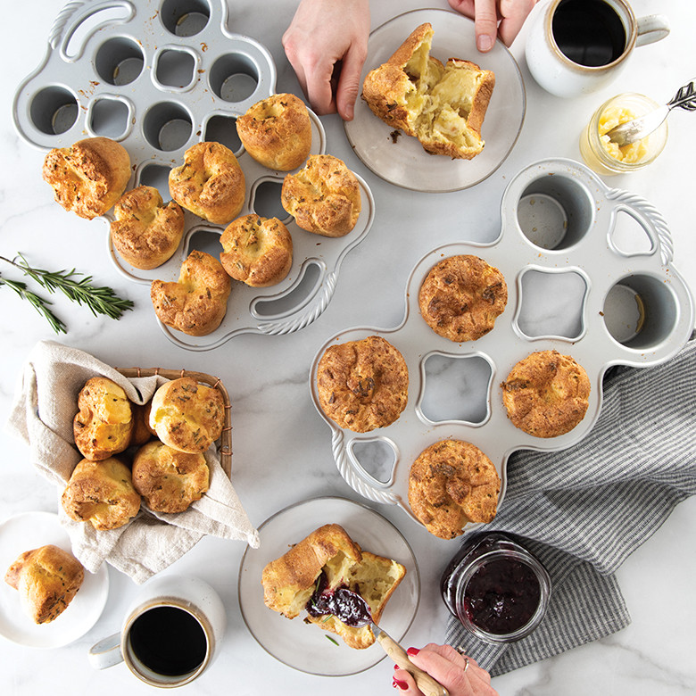 Nordic Ware aluminum popover pans with golden baked popovers, hands serving on plates with coffee and jam