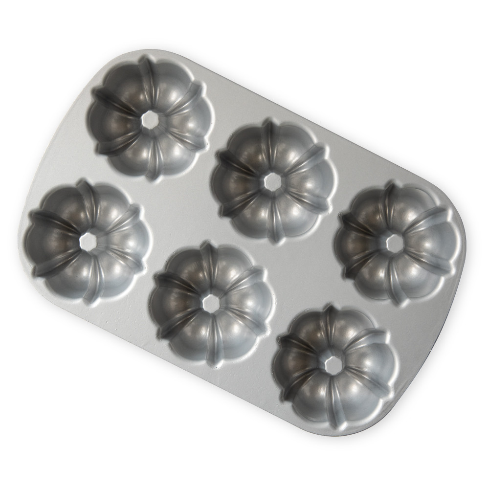 Nordic Ware aluminum Bundtlette pan with six fluted mini bundt cake molds, silver finish