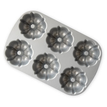 Nordic Ware aluminum Bundtlette pan with six fluted mini bundt cake molds, silver finish