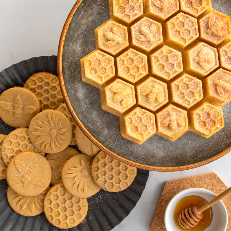 Golden honeycomb pull-apart cake from Nordic Ware pan with bee-stamped cookies and honey dipper