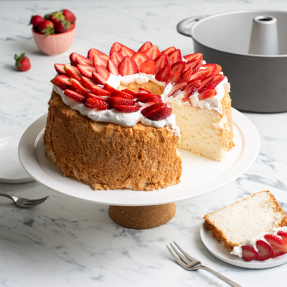 frosted pound cake topped with strawberries made with Nordic Ware aluminum pound cake pan with center tube
