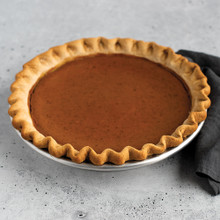 Golden brown pumpkin pie with fluted crust in Nordic Ware aluminum High Dome Covered Pie Pan