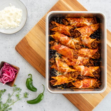 Nordic Ware aluminum rectangular baking pan with baked enchiladas, red sauce, melted cheese, natural finish