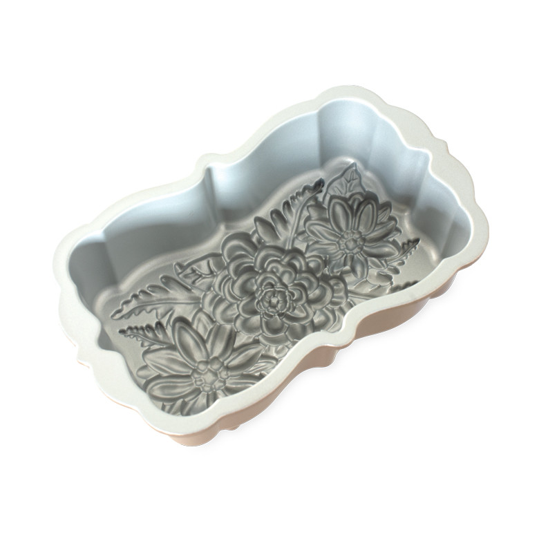 Nordic Ware aluminum Wildflower loaf pan with intricate floral design, scalloped edges, silver interior