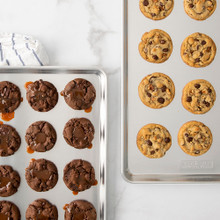 Nordic Ware aluminum big sheet baking pan with golden chocolate chip cookies, natural silver finish
