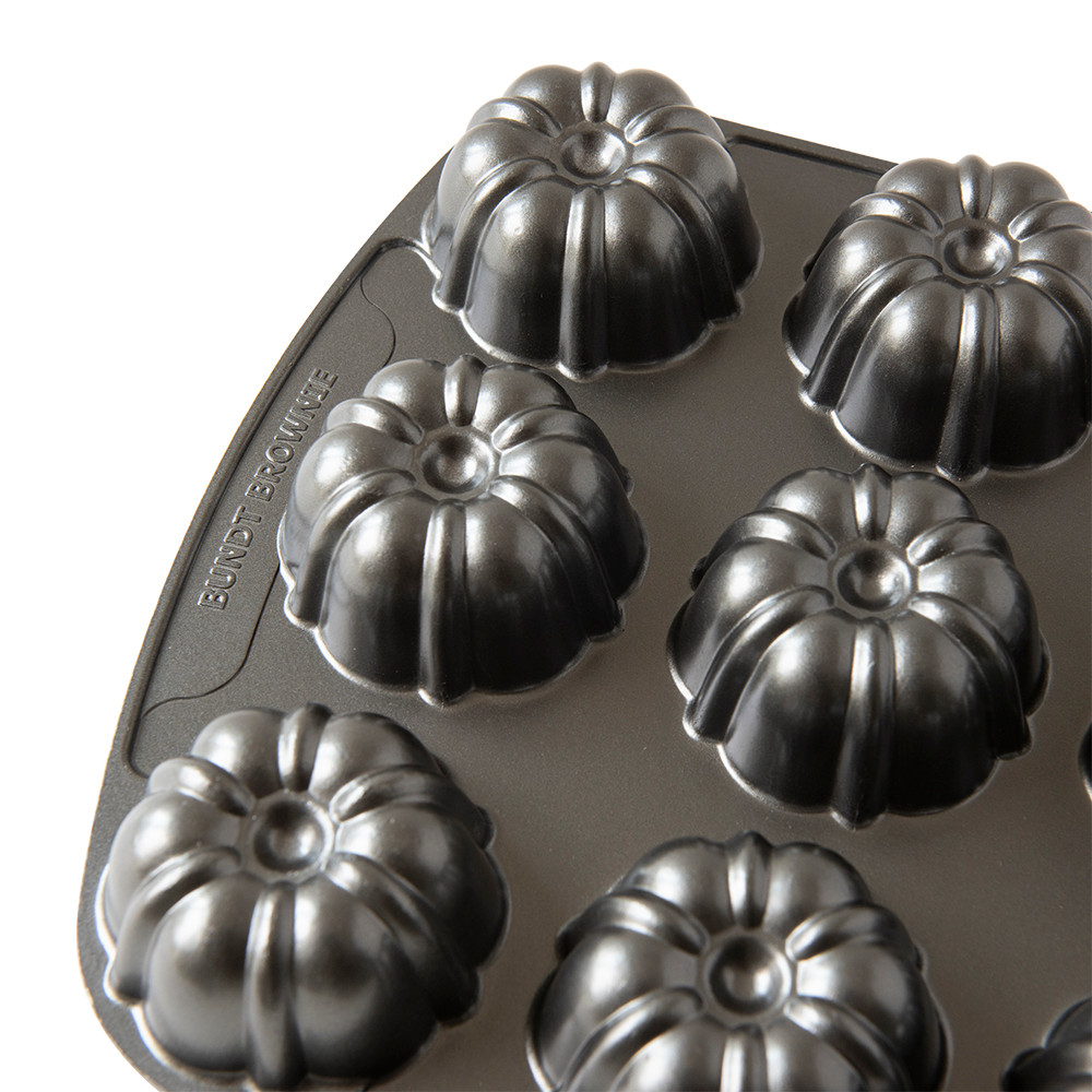 Nordic Ware aluminum bundt brownie pan with six individual fluted cavities, bronze non-stick finish