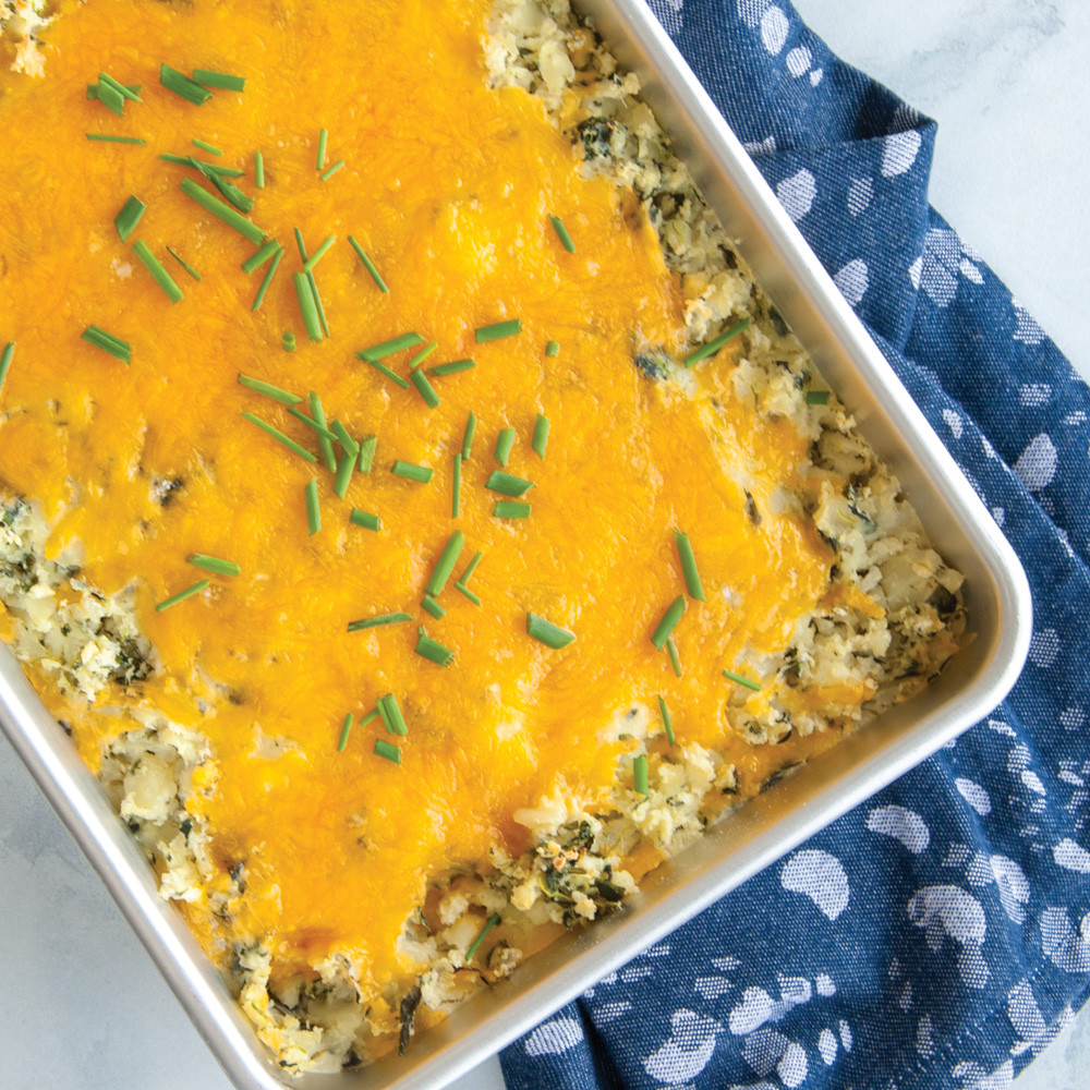 Cheesy potato casserole with melted cheddar and chives in Nordic Ware Prism aluminum 9x13 baking pan