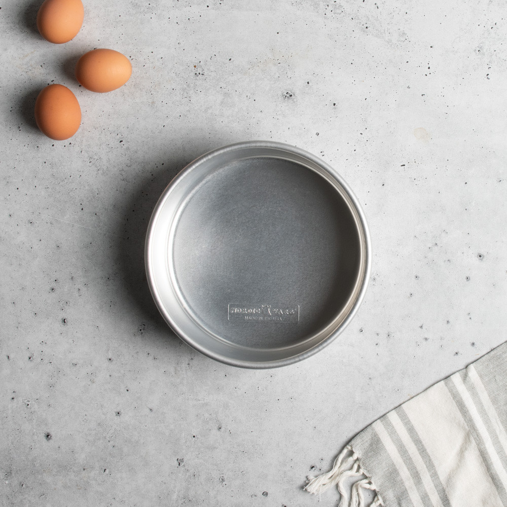 Nordic Ware Naturals 8-inch round aluminum layer cake pan with natural silver finish and raised rim