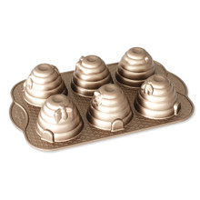 Nordic Ware toffee aluminum cakelet pan with six beehive-shaped molds, featuring ribbed dome design