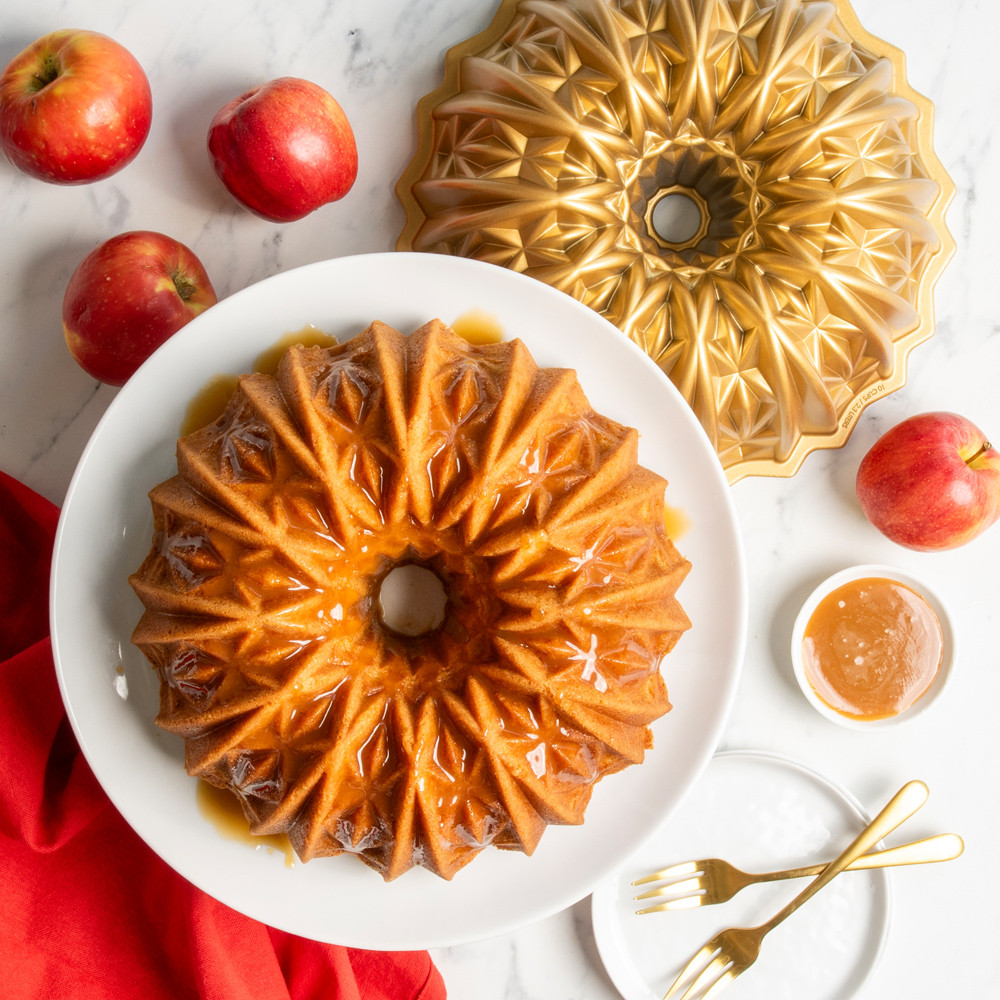 golden brown bundt cake on pedestal baked with nordic ware cut crystal bundt pan