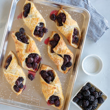 Nordic Ware aluminum jelly roll pan with golden baked pastries filled with dark berries, natural finish