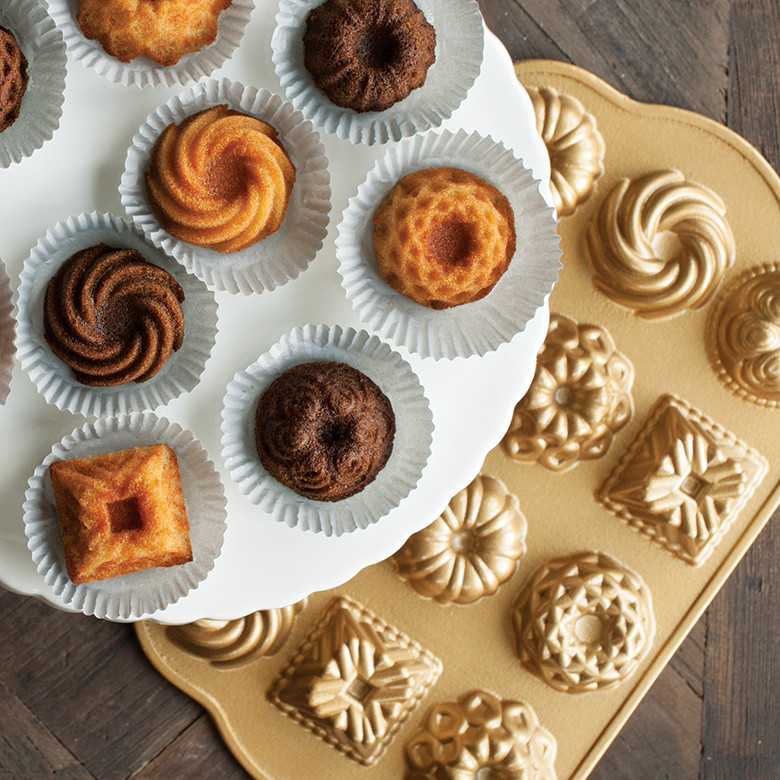 Nordic Ware Bundt Charms pan in gold aluminum with mini bundt cakes, showing detailed fluted cavities