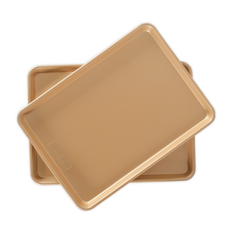Two Nordic Ware aluminum half sheet pans with nonstick coating, natural gold finish, rectangular with raised rims