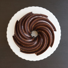Chocolate bundt cake in Nordic Ware Heritage pan showing spiral fluted design with chocolate glaze