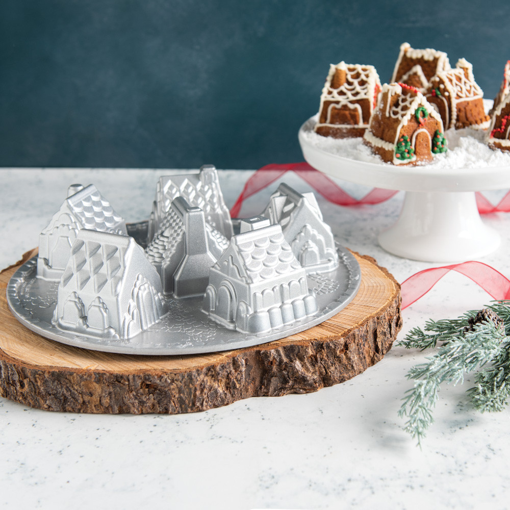 Golden brown gingerbread houses from Nordic Ware Cozy Village pan with white icing details