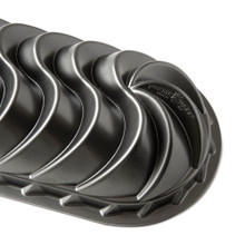 Nordic Ware Heritage aluminum loaf pan with decorative swirled exterior pattern, dark bronze finish