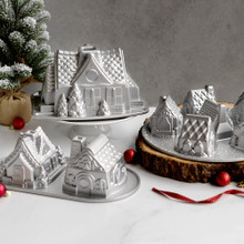 Nordic Ware aluminum gingerbread house bundt pans displaying detailed architectural designs with windows and doors