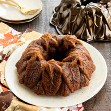 Golden pumpkin bundt cake in Nordic Ware Harvest Leaves aluminum pan, showing detailed leaf pattern design