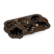 Nordic Ware Autumn Treats baking pan interior showing bronze nonstick surface with leaf and acorn shaped cavities