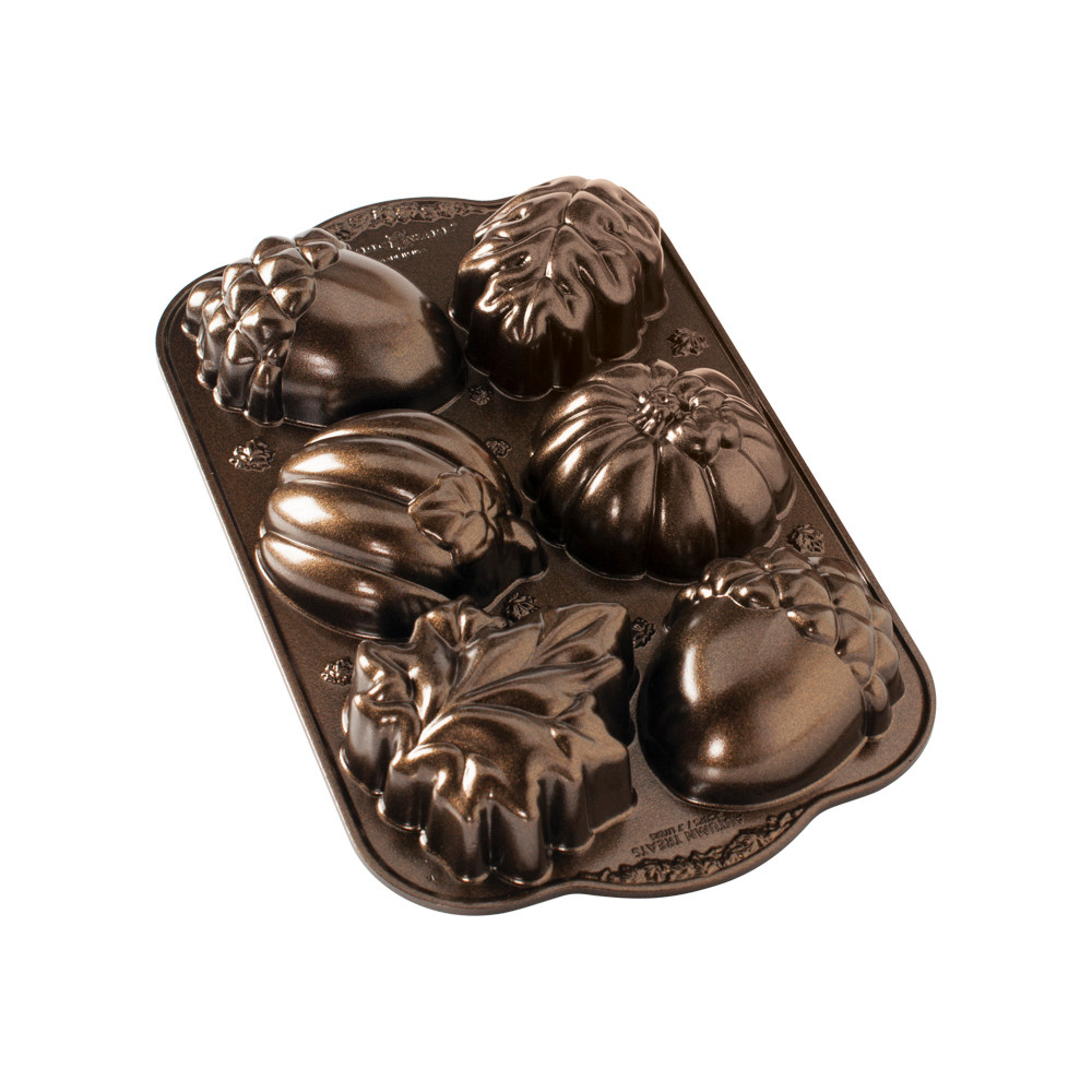 Nordic Ware bronze aluminum baking pan with 6 autumn-themed cavities: leaves, pumpkins, and acorns