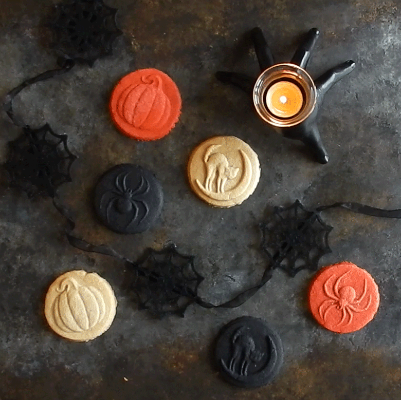 Nordic Ware Halloween cookie stamps creating decorated sugar cookies with pumpkin, bat, and ghost designs