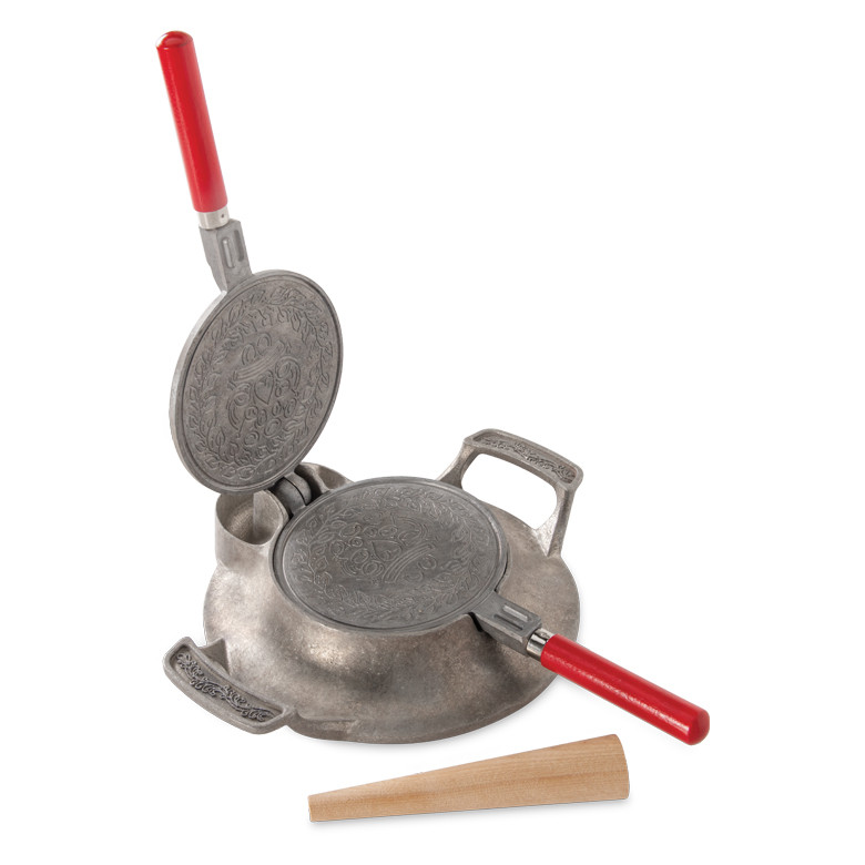 Nordic Ware cast aluminum krumkake iron open showing decorative snowflake pattern with wooden rolling cone
