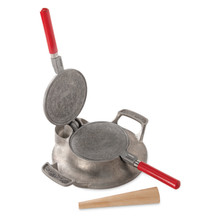 Nordic Ware cast aluminum krumkake iron open showing decorative snowflake pattern with wooden rolling cone