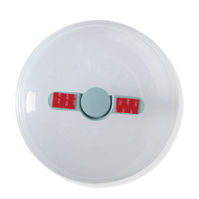Nordic Ware Up & Away spatter cover with red protective tape strip, overhead view showing compact design