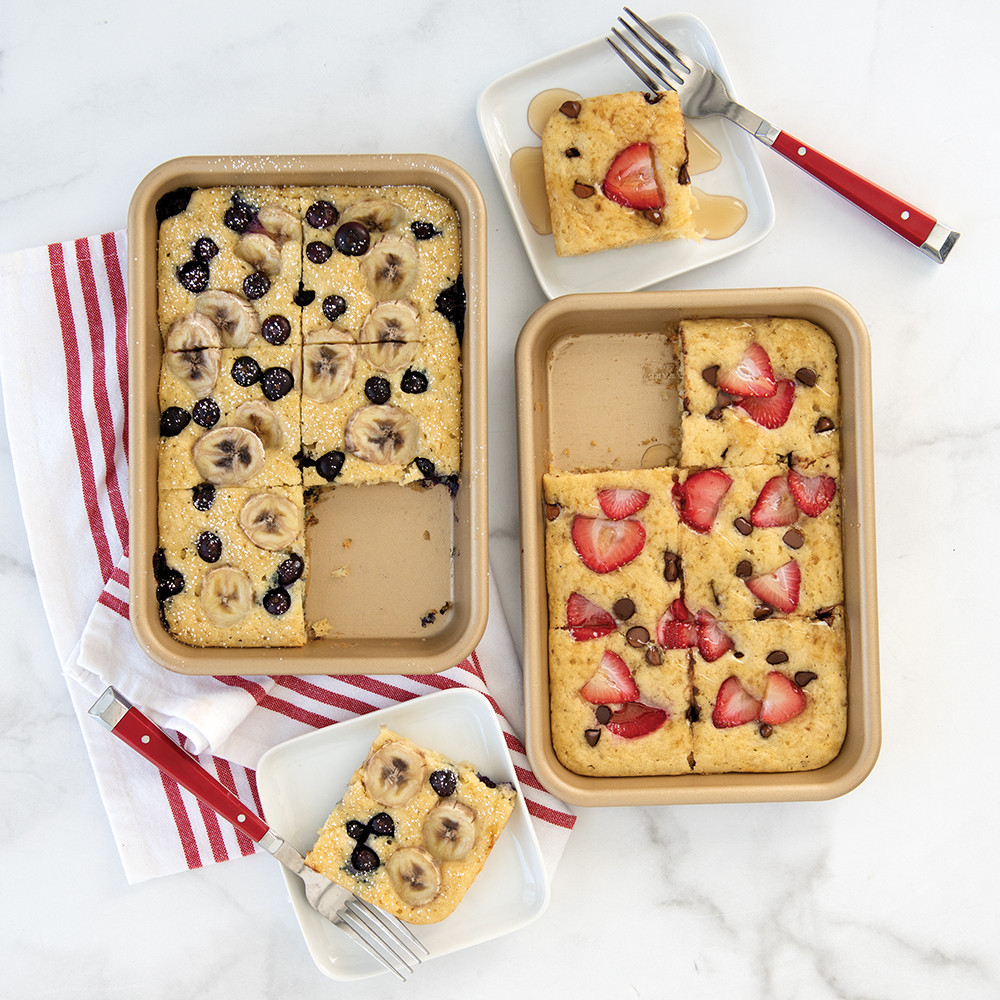 Two Nordic Ware aluminum nonstick eighth sheet pans with golden sheet pan pancakes topped with fresh berries