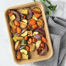Nordic Ware aluminum eighth sheet pan with roasted colorful vegetables, natural finish with raised edges
