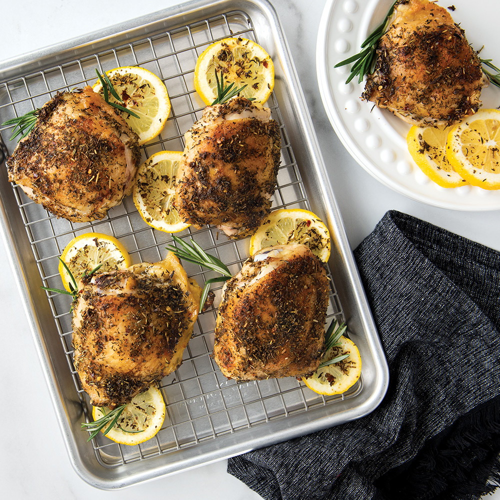 Nordic Ware aluminum quarter sheet pan with black nonstick cooling grid, topped with golden roasted lemon chicken pieces