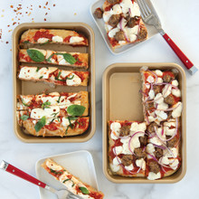 Two Nordic Ware aluminum eighth sheet pans with natural finish, one topped with baked mini pizzas with golden crust