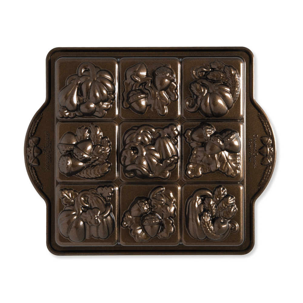 Nordic Ware aluminum Seasonal Squares baking pan with 9 square cavities featuring seasonal designs, natural finish