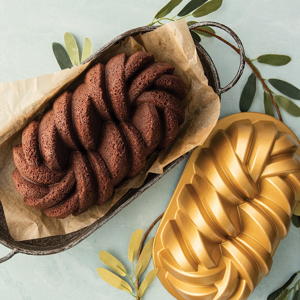 Nordic Ware aluminum braided loaf pan with twisted rope design, silver finish, shown with golden baked loaf