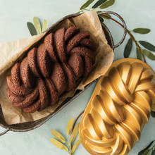 Nordic Ware aluminum braided loaf pan with twisted rope design, silver finish, shown with golden baked loaf