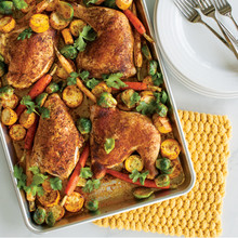 Nordic Ware aluminum half sheet pan with golden roasted chicken pieces, overhead angled view
