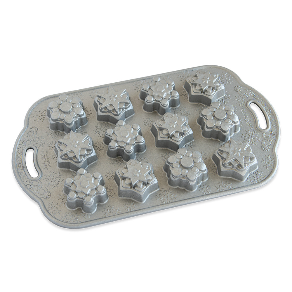 Nordic Ware aluminum baking pan with 12 snowflake-shaped cavities, natural silver finish