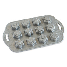 Nordic Ware aluminum baking pan with 12 snowflake-shaped cavities, natural silver finish