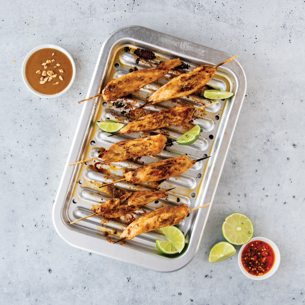 kabobs on Nordic Ware natural aluminum broiler pan with slotted rack, roasted vegetables and meat visible