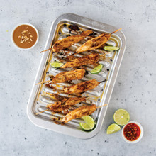 kabobs on Nordic Ware natural aluminum broiler pan with slotted rack, roasted vegetables and meat visible
