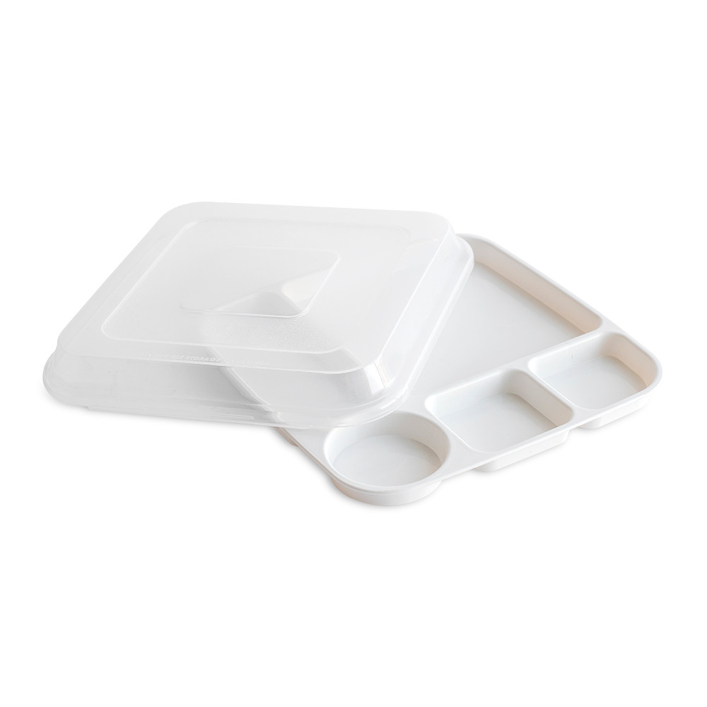 White rectangular divided dinner tray with three compartments containing colorful prepared foods