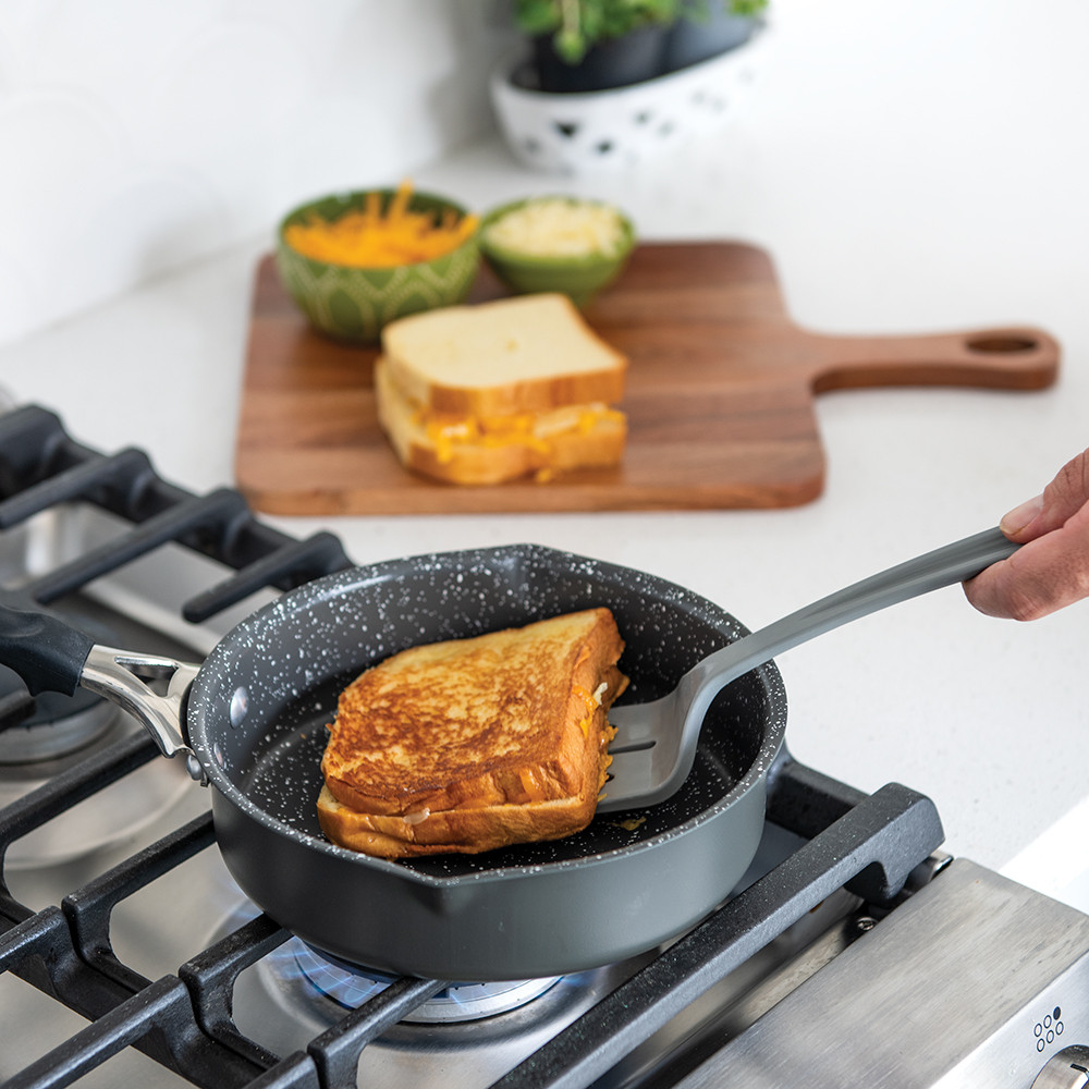 Nordic Ware Verde 8-inch ceramic nonstick skillet with golden grilled cheese sandwich cooking on stovetop