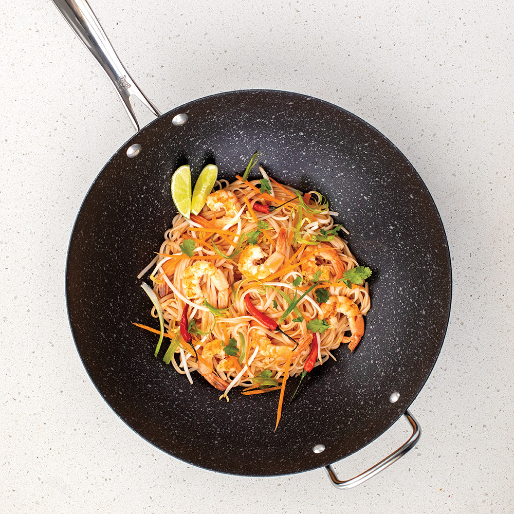 Nordic Ware 14-inch speckled black wok with cooked stir-fried noodles and vegetables
