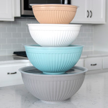 Nordic Ware 8-piece white prep bowls with lids, various sizes nested together on kitchen counter