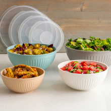 Nordic Ware 8-piece covered bowl set with white bowls containing colorful prepared foods and matching lids