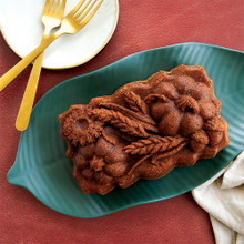 Sunflower Pumpkin Loaf Pan placed on a leaf-like green plate