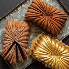 Two golden fluted loaf cakes displayed with Nordic Ware aluminum fluted loaf pan, showing detailed ridged design